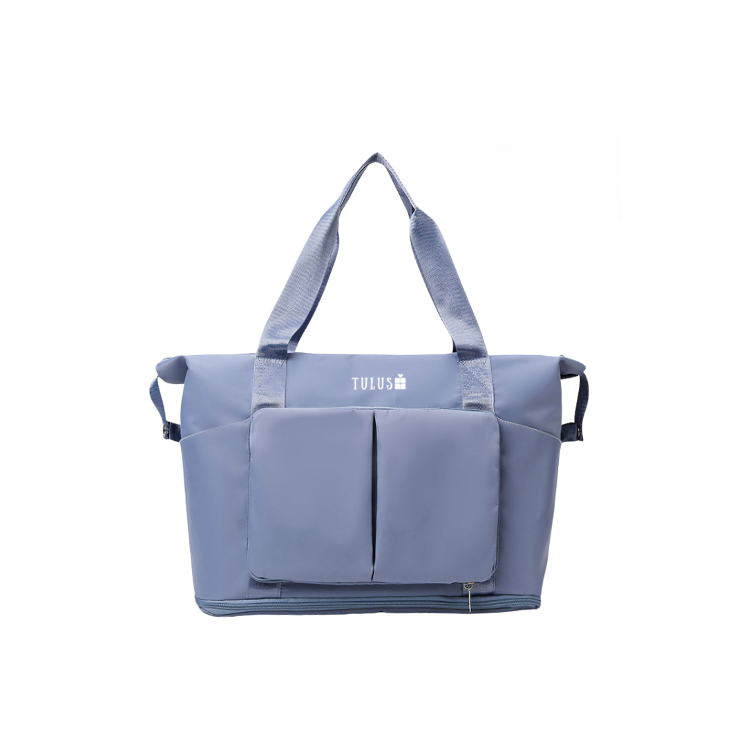 Foldable, expandable and waterproof tote and travel bag in dusty blue, spacious, accessible pockets with wet and dry compartments.