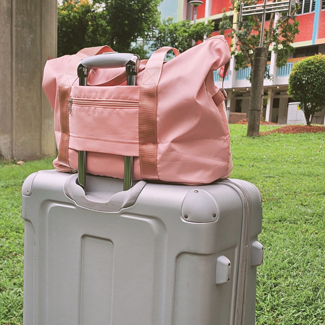 Tote bag with luggage slot, resting on luggage handle