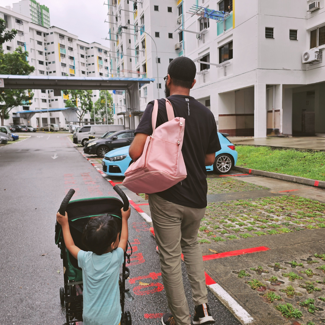 A man carrying a travel tote bag on his shoulder