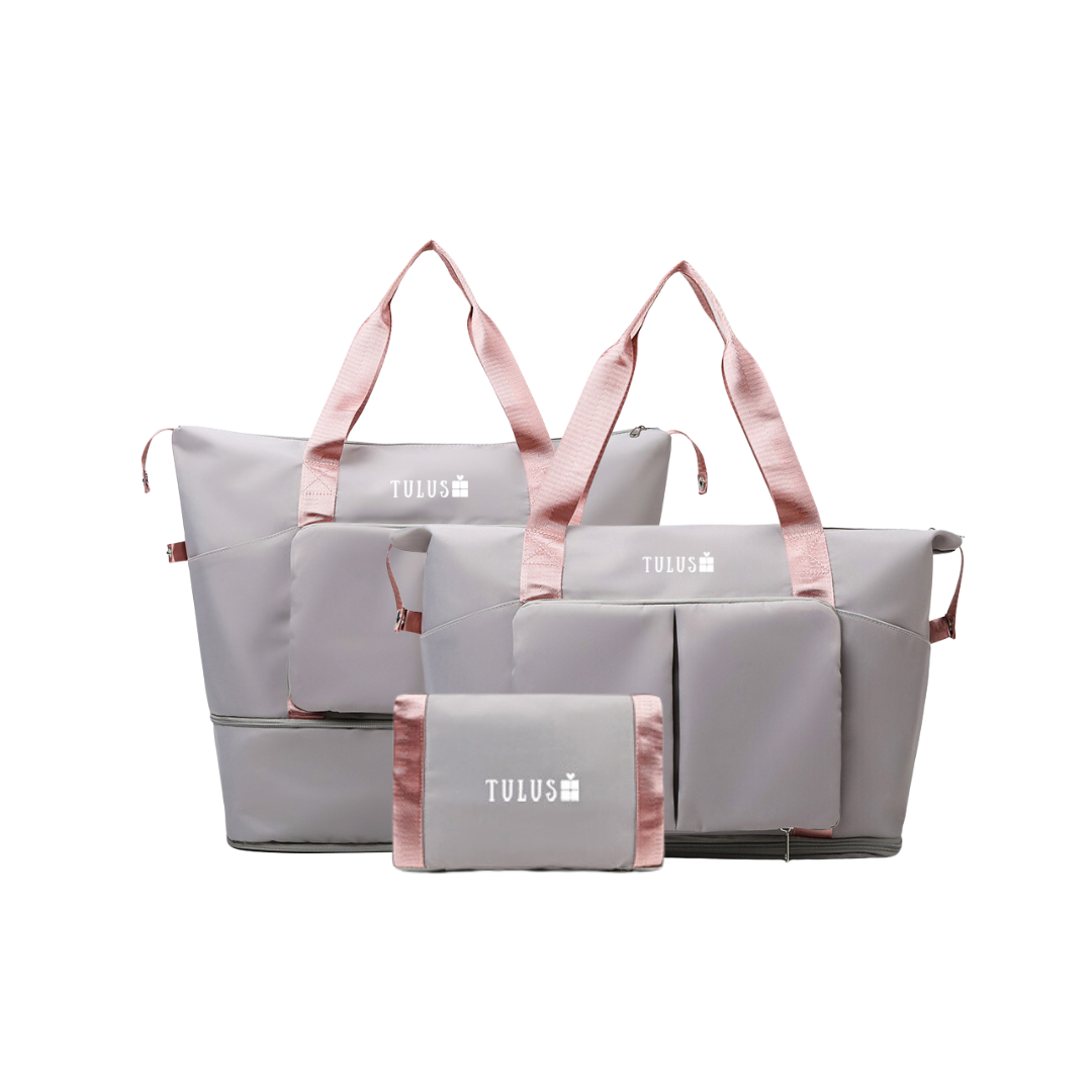 Foldable, expandable and waterproof tote and travel bag in grey with pink handles, spacious, accessible pockets with wet and dry compartments.