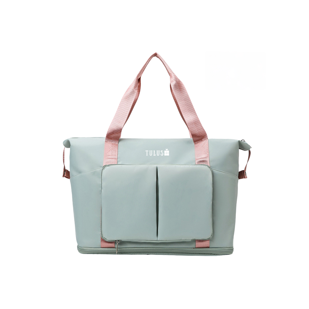 Foldable, expandable and waterproof tote and travel bag in light green with pink handles, spacious, accessible pockets with wet and dry compartments.